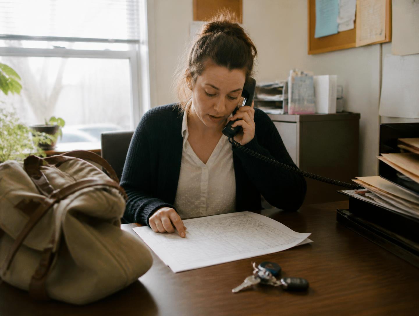 Home health coordinator reviewing caregiver schedules at an agency office